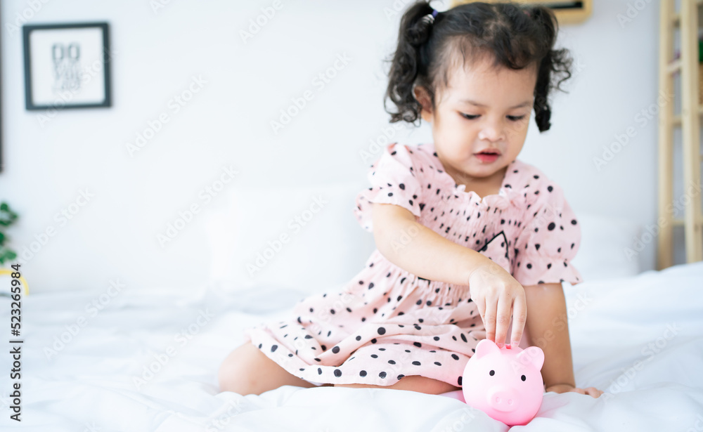 baby girl inserting a coin into piggybank. asian cute girl saving money putting coins into piggy bank.
kid saving money for future concept. baby girl inserting a coin into piggybank. asian cute girl saving money putting coins into piggy bank.
kid saving money for future concept.