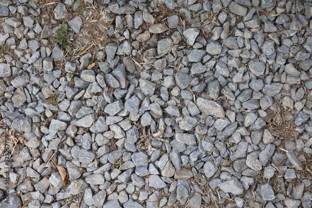 Gray gravel pattern, stone footpath closeup with dirt and textured stones Gray gravel pattern, stone footpath closeup with dirt and textured stones