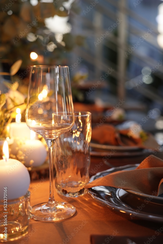 Elegant table setting with beautiful decor and burning candles indoors
