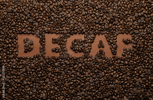 фотографія Word Decaf in coffee beans, top view
