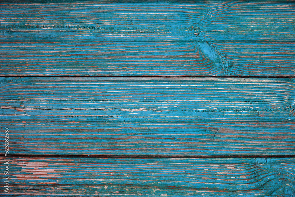 Texture of Old cracked aquamarine or celadon boards for background and design. The texture of dry wood planks