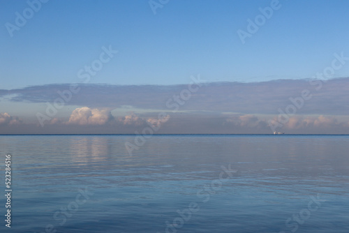 calm ocean waves and cloud reflections and sky