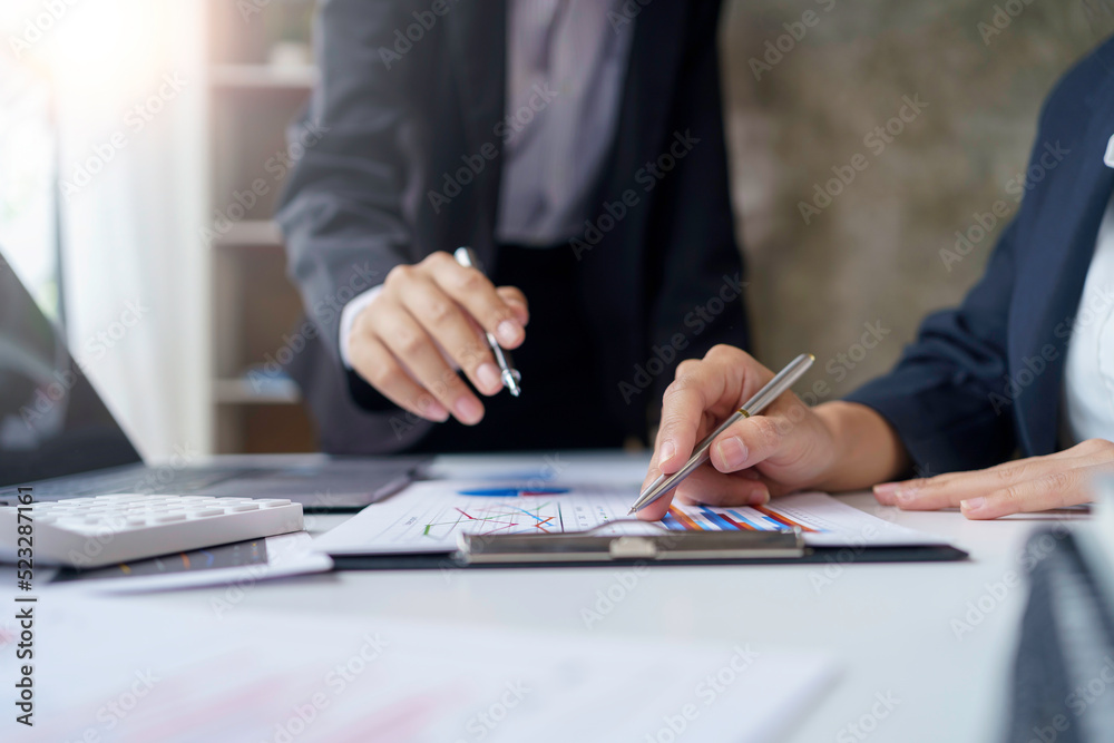 Close-up of a group of business meeting to discuss plan analyze graph and chart and calculate company performance, balance sheet, financial statement, income statement and deficit. Close-up of a group of business meeting to discuss plan analyze graph and chart and calculate company performance, balance sheet, financial statement, income statement and deficit.
