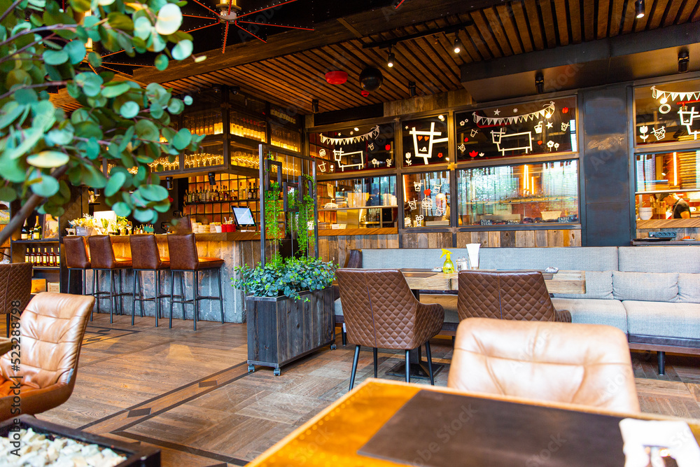Fototapeta premium Interior of modern loft style restaurant with live plants