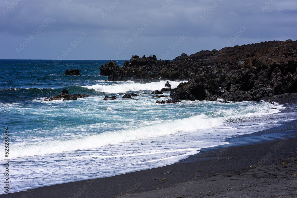 Ocean waves crashing on hardened black lava.Lanzarote, Canary Islands, Spain