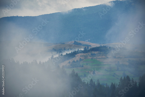 Mountain landscape with fog. Gloomy, rainy autumn in the Carpathian mountains