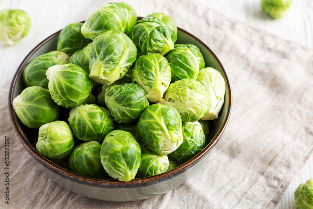 Raw Organic Brussel Sprouts in a Bowl, low angle view. Raw Organic Brussel Sprouts in a Bowl, low angle view.
