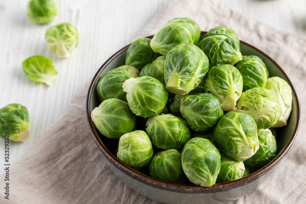 Raw Organic Brussel Sprouts in a Bowl, low angle view. Raw Organic Brussel Sprouts in a Bowl, low angle view.