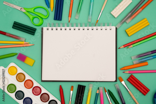 Back to school soon. buying stationery, flatlay, a place to copy your text or advertising on a white tablet. Bright background.