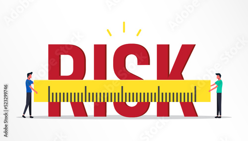 Businessmen measure the word risk with measuring ruler.