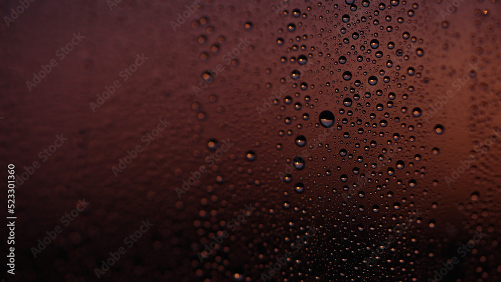 Water drops on window glass with sunset light Water drops on window glass with sunset light