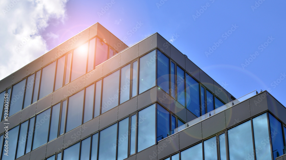Fototapeta premium Architecture details. Modern glass building facade in sunny day. Business background.