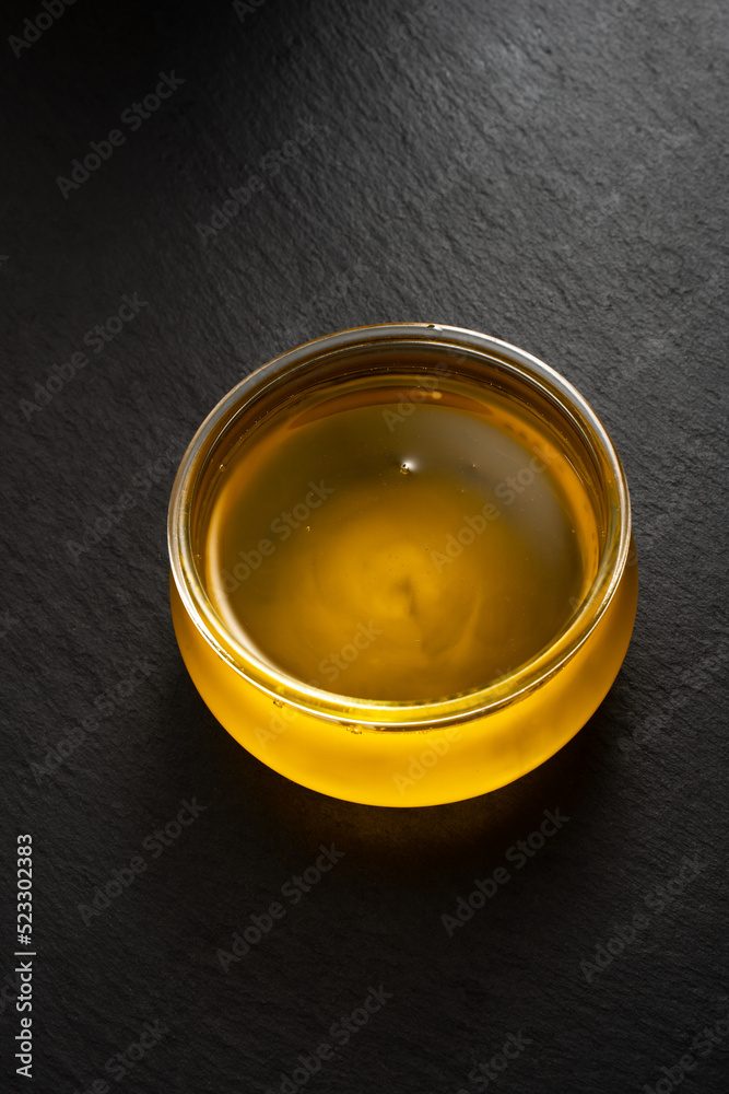bowl of ghee on dark background bowl of ghee on dark background