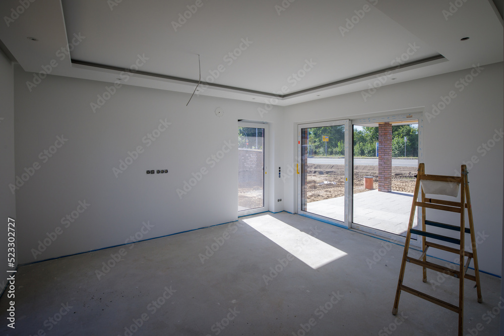 Fototapeta premium in the new house there is a folding ladder in an empty room