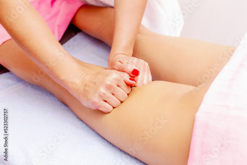 Young woman getting a massage at the spa. Body care. Therapeutic foot massage in the spa salon. Skin care, well-being