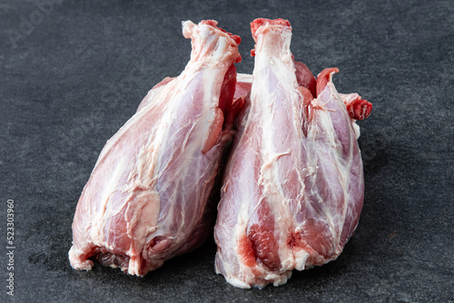 Pork ribs. Raw meat on a gray stne background photo