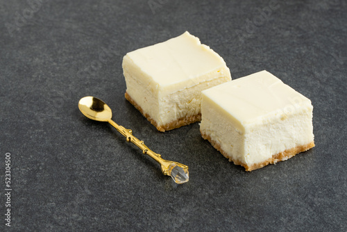 Slice of plain New York Cheesecake on stone table