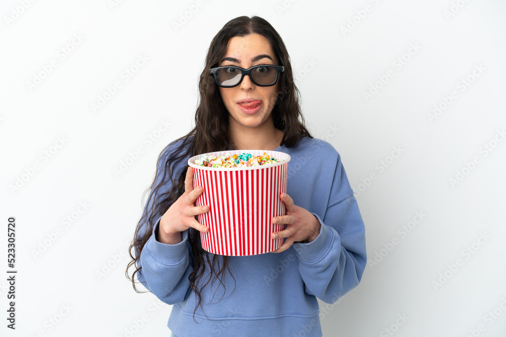 Young caucasian woman isolated on white background with 3d glasses and holding a big bucket of popcorns Young caucasian woman isolated on white background with 3d glasses and holding a big bucket of popcorns