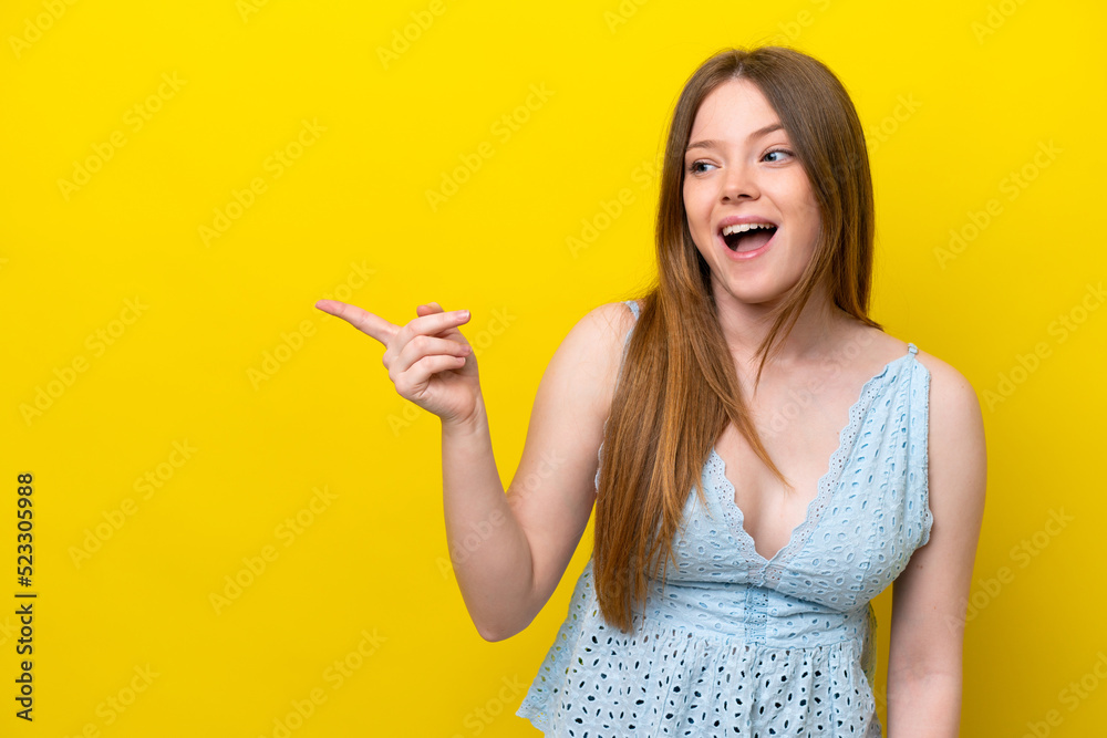 Young caucasian woman isolated on yellow background intending to realizes the solution while lifting a finger up Young caucasian woman isolated on yellow background intending to realizes the solution while lifting a finger up