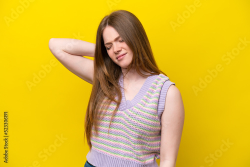 Young caucasian woman isolated on yellow background with neckache