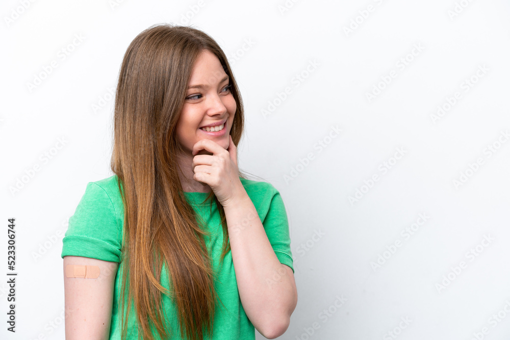 Young caucasian woman wearing a band aids isolated on white background thinking an idea and looking side Young caucasian woman wearing a band aids isolated on white background thinking an idea and looking side