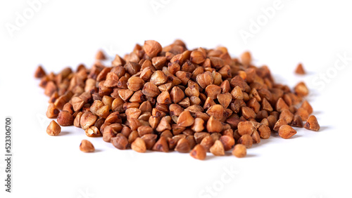 Pile of buckwheat seeds isolated on white background, closeup