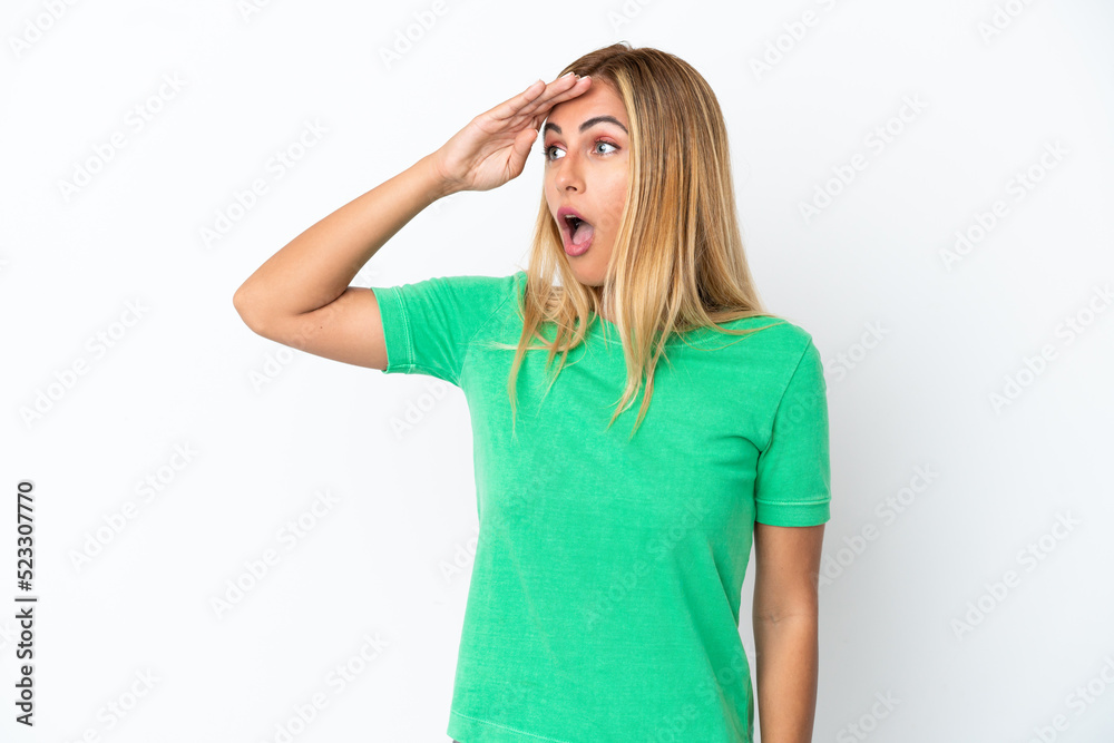 Blonde Uruguayan girl isolated on white background with surprise expression while looking side Blonde Uruguayan girl isolated on white background with surprise expression while looking side