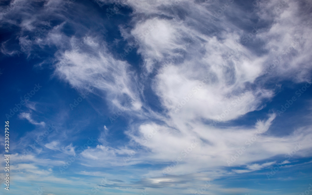 Intense and luminous blue sky with white cirrus clouds perfect for backgrounds and graphic resources Intense and luminous blue sky with white cirrus clouds perfect for backgrounds and graphic resources