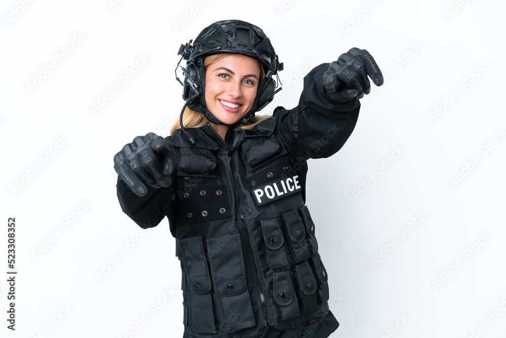 SWAT caucasian woman isolated on white background points finger at you while smiling SWAT caucasian woman isolated on white background points finger at you while smiling