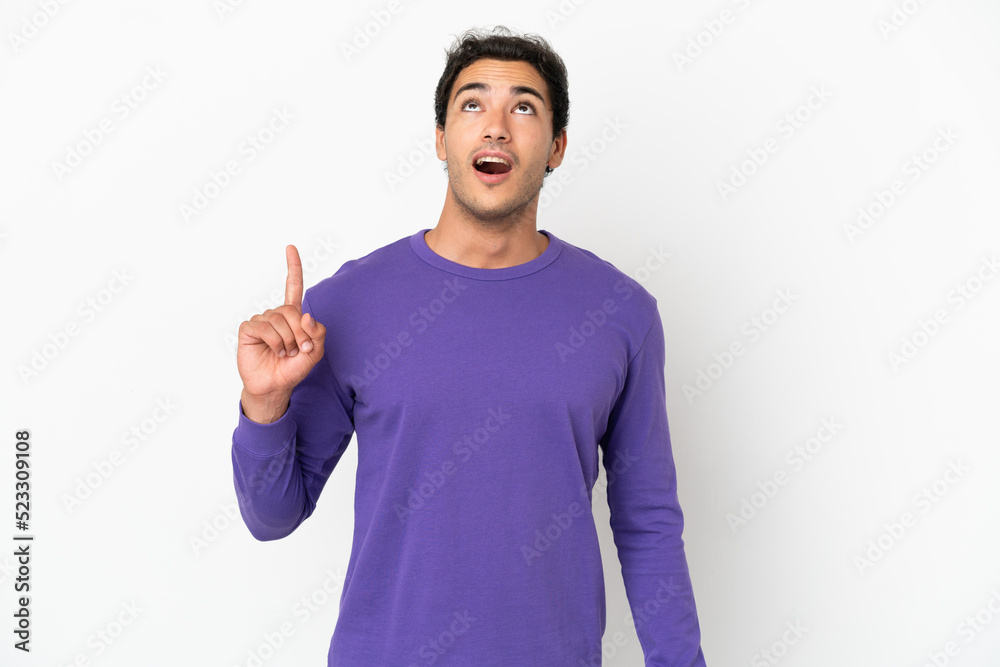 Caucasian handsome man over isolated white background pointing up and surprised Caucasian handsome man over isolated white background pointing up and surprised
