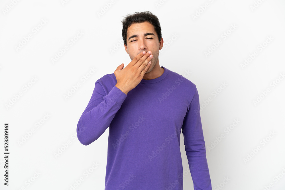 Caucasian handsome man over isolated white background yawning and covering wide open mouth with hand Caucasian handsome man over isolated white background yawning and covering wide open mouth with hand