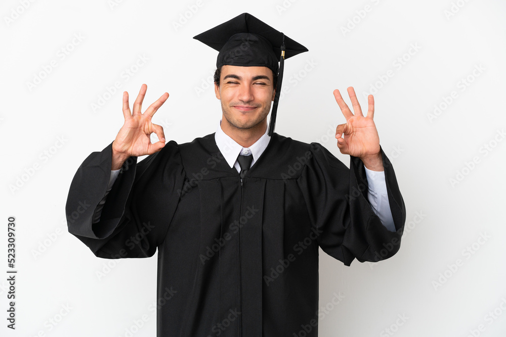 Young university graduate over isolated white background in zen pose Young university graduate over isolated white background in zen pose
