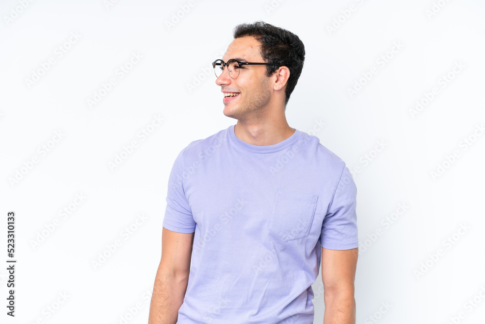 Young caucasian man isolated on white background looking to the side and smiling Young caucasian man isolated on white background looking to the side and smiling