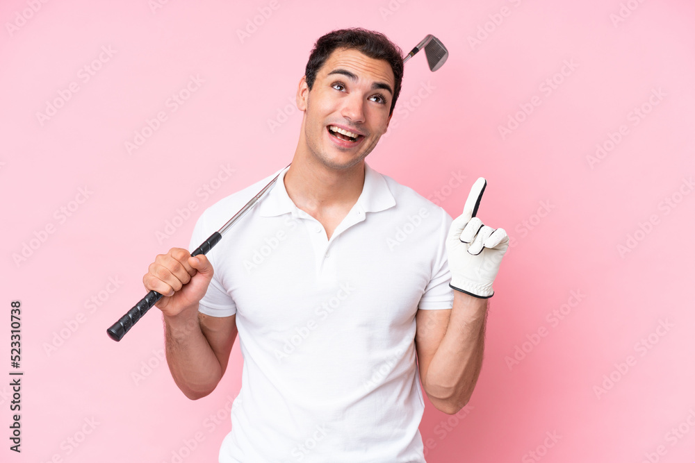 Young golfer player man isolated on pink background pointing up a great idea Young golfer player man isolated on pink background pointing up a great idea