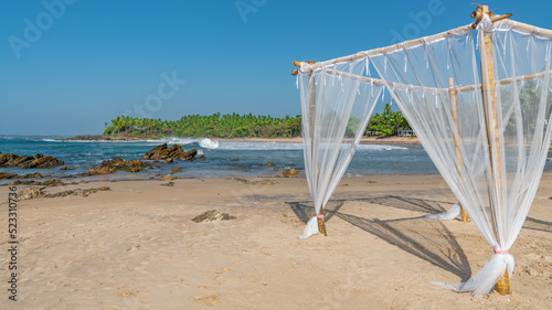 Light bamboo canopy on a deserted beach