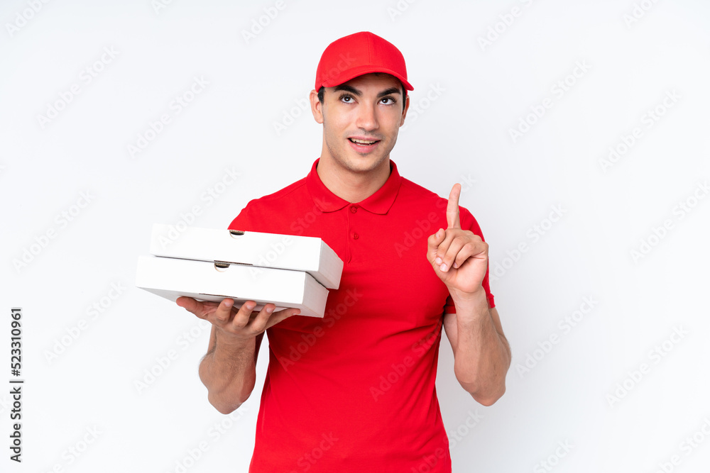 Pizza delivery caucasian man with work uniform picking up pizza boxes isolated on white background thinking an idea pointing the finger up Pizza delivery caucasian man with work uniform picking up pizza boxes isolated on white background thinking an idea pointing the finger up