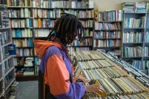 Woman seen searching through vinyl records photo