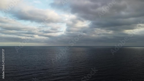 Wallpaper Mural Aerial view from above on calm azure sea and volcanic rocky shores. Small waves on water surface in motion blur. Nature ocean sea beach background. Nobody. Aerial flying drone view over the sea ocean. Torontodigital.ca