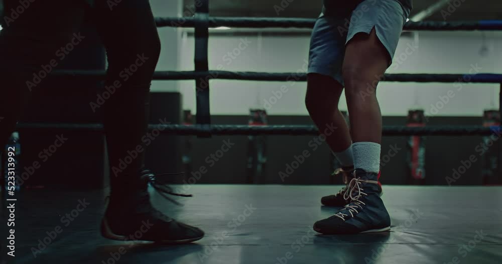 dark-skinned fighter is training with coach, closeup view on legs on ring, 4K, Prores dark-skinned fighter is training with coach, closeup view on legs on ring, 4K, Prores