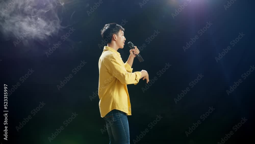 Side View Of Young Asian Boy Holding A Microphone And Rapping On The White Smoke Black Background
Side View Of Young Asian Boy Holding A Microphone And Rapping On The White Smoke Black Background