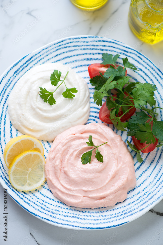 Greek meze made of fish roe or taramosalata served on a blue and white plate, middle close-up, elevated view, vertical shot Greek meze made of fish roe or taramosalata served on a blue and white plate, middle close-up, elevated view, vertical shot