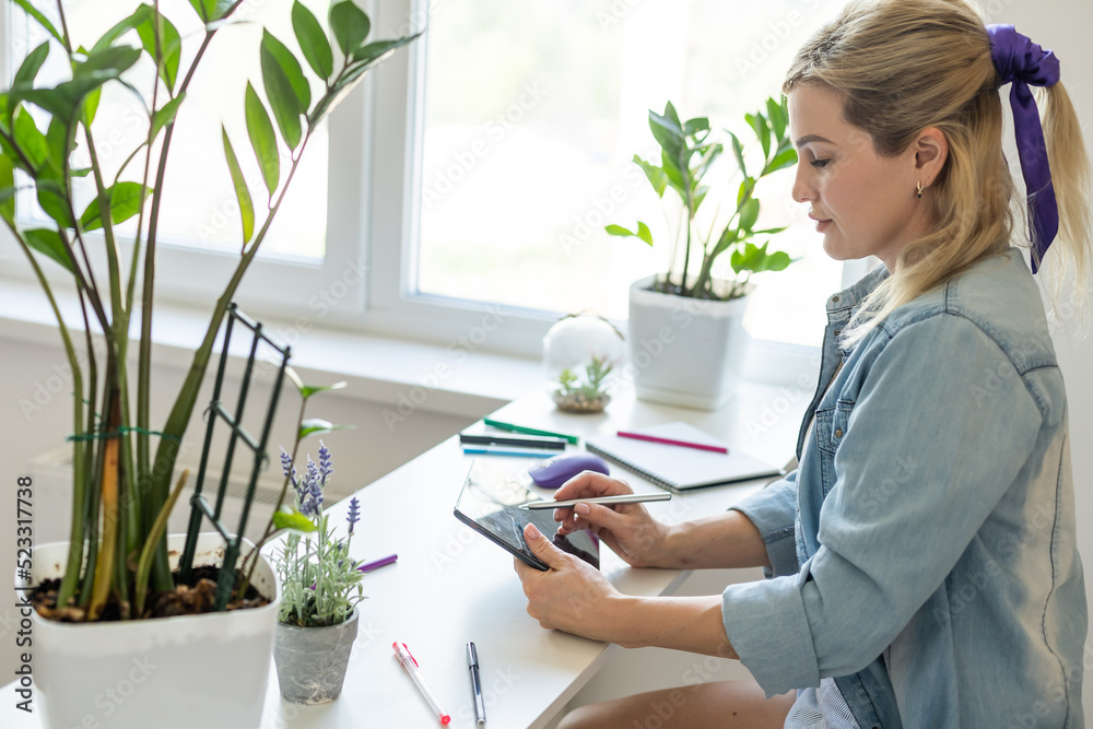 Young businesswoman using digital tablet in her office Young businesswoman using digital tablet in her office