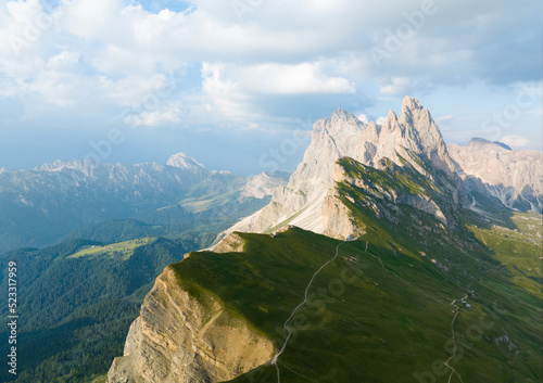 View from above, stunning aerial view of the mountain range of Seceda during a beautiful sunny day. The Seceda with its 2.500 meters is the highest vantage point in Val Gardena, Dolomites, Italy
