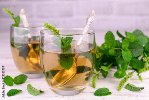 Mint tea in glasses on a white background.Close-up. 
