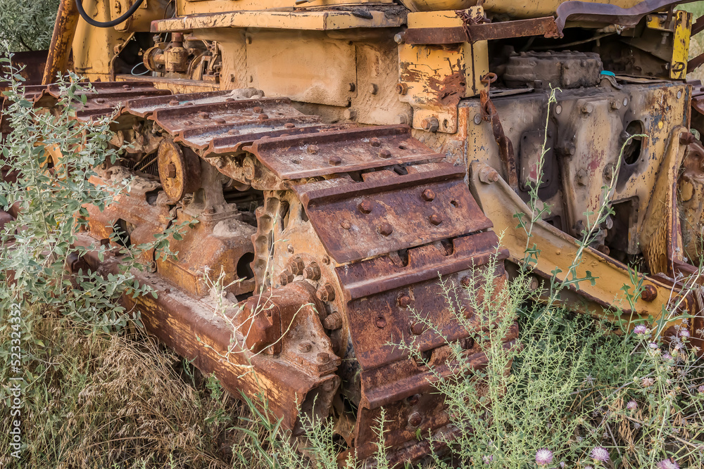 Old rusty bulldozer caterpillars in nature close-up