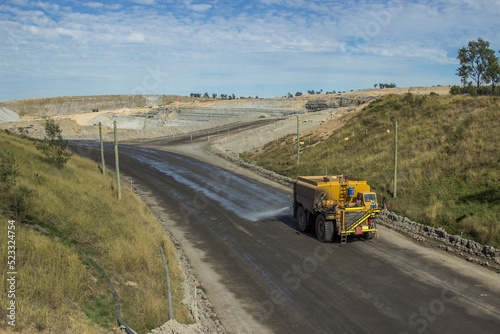 Mine truck spraying the roads with water to minimise dust
