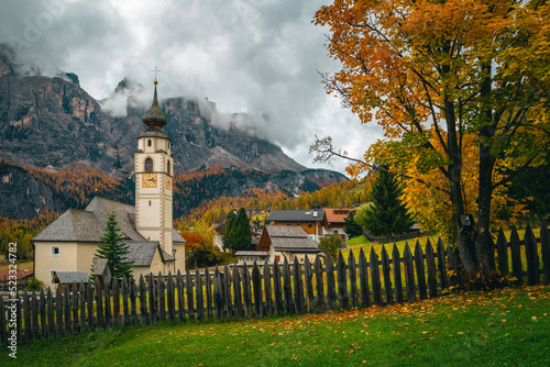 Fabulous alpine village with traditional mountain church, Dolomites, Colfosco, Italy photo