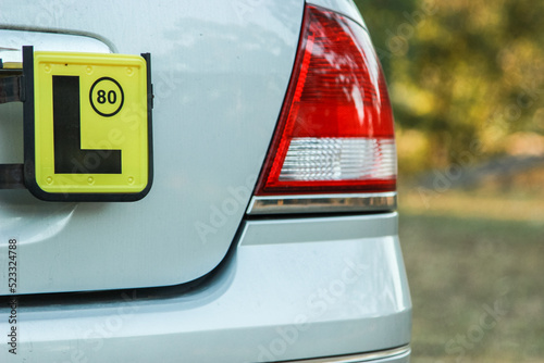 L license plate on the back of a car