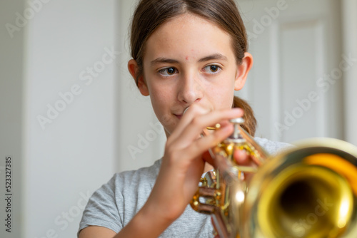 school student practising trumpet at home