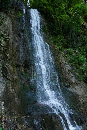 mountain waterfall with clean drinking water on the route in a hike in the mountains